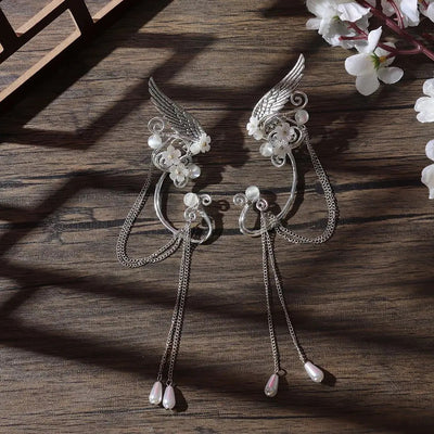 Galadriel Elven Ear Cuff Set - An elegant curved ear cuff designed to resemble the shape of an elf ear, decorated with pearls, flowers, and a silver angel wing.