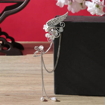 Galadriel Elven Ear Cuff Set - An elegant curved ear cuff designed to resemble the shape of an elf ear, decorated with pearls, flowers, and a silver angel wing.