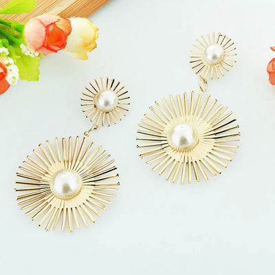 Solaris Radiant Statement Earrings - Large statement earrings featuring a round starburst shape with long rays radiating out from a central pearl.