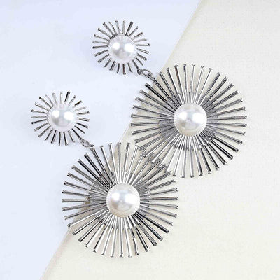Solaris Radiant Statement Earrings - Large statement earrings featuring a round starburst shape with long rays radiating out from a central pearl.