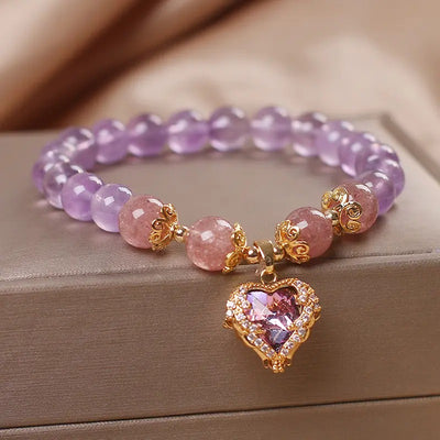 Violette Amethyst Stretch Bracelet - An elegant bracelet made from round purple and pink beads with a heart-shaped topaz as the centre piece.