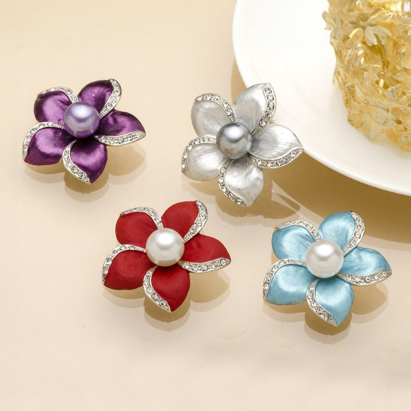 Amara Enamel Anemone Brooch - A lovely floral brooch featuring five coloured enamel petals clustered around a central pearl, each petal edged along one wide with small quartz crystals.