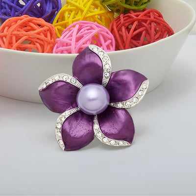 Amara Enamel Anemone Brooch - A lovely floral brooch featuring five coloured enamel petals clustered around a central pearl, each petal edged along one wide with small quartz crystals.