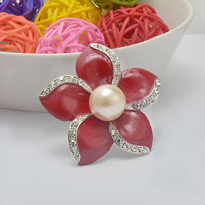 Amara Enamel Anemone Brooch - A lovely floral brooch featuring five coloured enamel petals clustered around a central pearl, each petal edged along one wide with small quartz crystals.