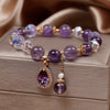 Amaranthe Amethyst Stretch Bracelet - An elegant bracelet made from round amethyst, rose quartz, and clear quartz beads with a teardrop-shaped amethyst as the centre piece.