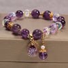 Amaranthe Amethyst Stretch Bracelet - An elegant bracelet made from round amethyst, rose quartz, and clear quartz beads with a teardrop-shaped amethyst as the centre piece.