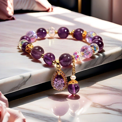 Amaranthe Amethyst Stretch Bracelet - An elegant bracelet made from round amethyst, rose quartz, and clear quartz beads with a teardrop-shaped amethyst as the centre piece.