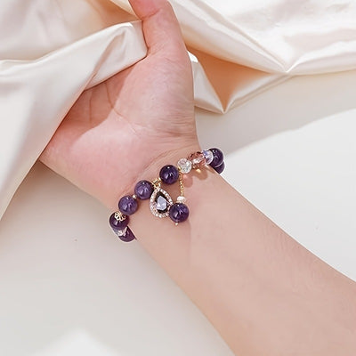 Amaranthe Amethyst Stretch Bracelet - An elegant bracelet made from round amethyst, rose quartz, and clear quartz beads with a teardrop-shaped amethyst as the centre piece.