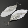 The Angel Feather Earrings - Large feathered earrings available in white, black, red, purple, and blue.