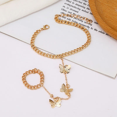 Anjana Butterfly Hand Chain Bracelet - A simple hand chain with a loop around the wrist and one around the finger, and a length of finer chain between the two decorated with tiny butterfly charms.