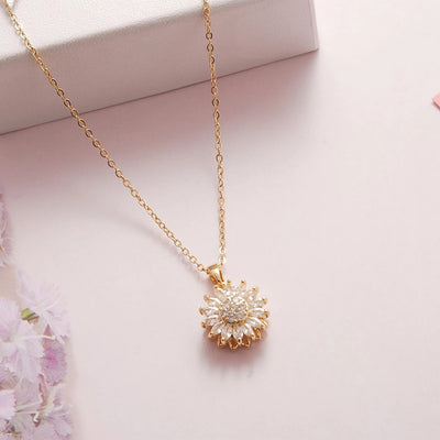 Annie Sunflower Fidget Spinner Necklace - A tiny round crystal pendant designed to look like a stylised sunflower, which features a rotating plate so it can be twirled for a calming meditative effect.