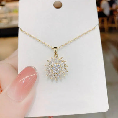 Annie Sunflower Fidget Spinner Necklace - A tiny round crystal pendant designed to look like a stylised sunflower, which features a rotating plate so it can be twirled for a calming meditative effect.