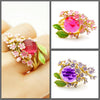 The Anthousai Ring - A lovely vibrant floral ring with a large coloured crystal surrounded by tiny enamel flowers and leaves.