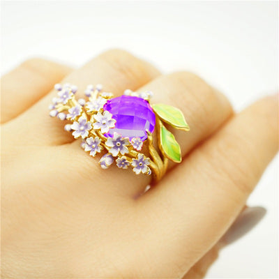 The Anthousai Ring - A lovely vibrant floral ring with a large coloured crystal surrounded by tiny enamel flowers and leaves.