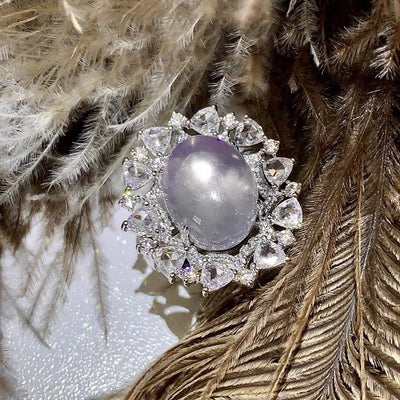 Arabelle Luxury Crystal Adjustable Ring - A large cocktail ring featuring a single blue-white opal surrounded by a cluster of elegantly-carved quartz crystals.