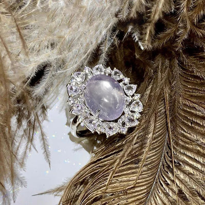 Arabelle Luxury Crystal Adjustable Ring - A large cocktail ring featuring a single blue-white opal surrounded by a cluster of elegantly-carved quartz crystals.