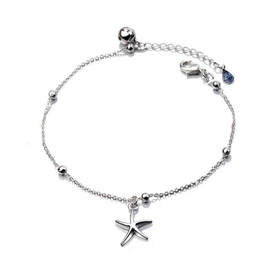 Ariel Starfish Charm Bracelet - A very delicate silver-coloured chain bracelet adorned with a tiny starfish charm and a cute little bell.