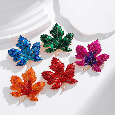 Aurelia Maple Leaf Enamel Brooch - A large, colourful enamel brooch shaped like a stylised maple leaf, studded with coloured crystals and metallic enamel paint.