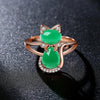 Bastet II Adjustable Ring - A stylish cat-themed ring composed of two large artificial opals framed by tiny quartz crystals, available in red or green.