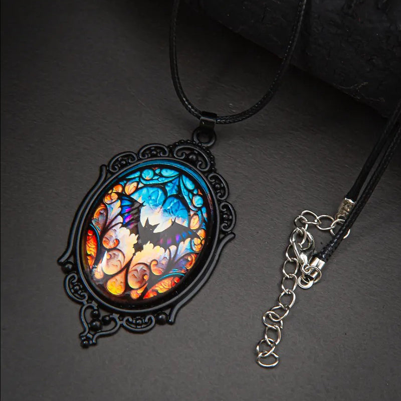 Batty Bat Cameo Necklace - A large gothic glass cabochon featuring an image of a stylized bat against an orange-blue ombre background.
