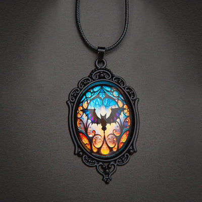 Batty Bat Cameo Necklace - A large gothic glass cabochon featuring an image of a stylized bat against an orange-blue ombre background.