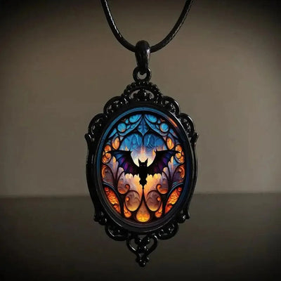 Batty Bat Cameo Necklace - A large gothic glass cabochon featuring an image of a stylized bat against an orange-blue ombre background.