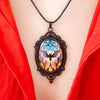 Batty Bat Cameo Necklace - A large gothic glass cabochon featuring an image of a stylized bat against an orange-blue ombre background.