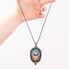 Batty Bat Cameo Necklace - A large gothic glass cabochon featuring an image of a stylized bat against an orange-blue ombre background.