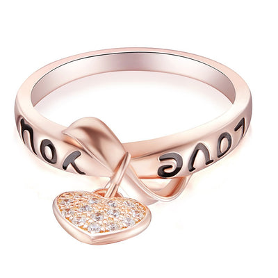 Be Still My Heart Ring - A rose gold ring with a heart and ribbon theme.