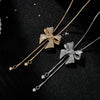 Bethany Bowknot Adjustable Sweater Chain - A long, slender snake chain with a stylised pave bow pendant set on it, which can be adjusted so the chains hang different lengths.