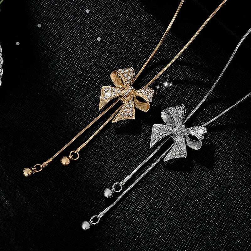 Bethany Bowknot Adjustable Sweater Chain - A long, slender snake chain with a stylised pave bow pendant set on it, which can be adjusted so the chains hang different lengths.