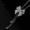 Bethany Bowknot Adjustable Sweater Chain - A long, slender snake chain with a stylised pave bow pendant set on it, which can be adjusted so the chains hang different lengths.
