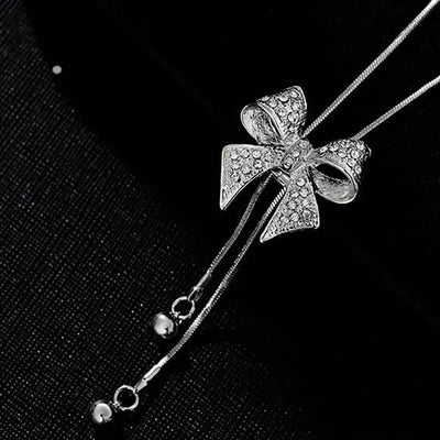 Bethany Bowknot Adjustable Sweater Chain - A long, slender snake chain with a stylised pave bow pendant set on it, which can be adjusted so the chains hang different lengths.