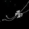 Bethany Bowknot Adjustable Sweater Chain - A long, slender snake chain with a stylised pave bow pendant set on it, which can be adjusted so the chains hang different lengths.