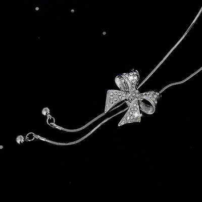 Bethany Bowknot Adjustable Sweater Chain - A long, slender snake chain with a stylised pave bow pendant set on it, which can be adjusted so the chains hang different lengths.