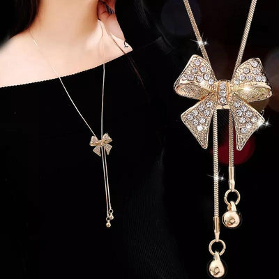 Bethany Bowknot Adjustable Sweater Chain - A long, slender snake chain with a stylised pave bow pendant set on it, which can be adjusted so the chains hang different lengths.