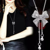 Bethany Bowknot Adjustable Sweater Chain - A long, slender snake chain with a stylised pave bow pendant set on it, which can be adjusted so the chains hang different lengths.
