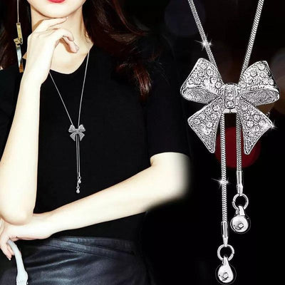 Bethany Bowknot Adjustable Sweater Chain - A long, slender snake chain with a stylised pave bow pendant set on it, which can be adjusted so the chains hang different lengths.