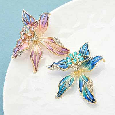 Brigette Orchid Sculpted Resin Brooch - An elegant floral brooch available in blue, pink, or purple, with shimmering crystals and semi-translucent resin.