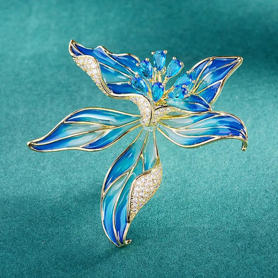 Brigette Orchid Sculpted Resin Brooch - An elegant floral brooch available in blue, pink, or purple, with shimmering crystals and semi-translucent resin.