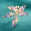 Brigette Orchid Sculpted Resin Brooch - An elegant floral brooch available in blue, pink, or purple, with shimmering crystals and semi-translucent resin.