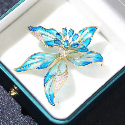 Brigette Orchid Sculpted Resin Brooch - An elegant floral brooch available in blue, pink, or purple, with shimmering crystals and semi-translucent resin.