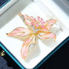 Brigette Orchid Sculpted Resin Brooch - An elegant floral brooch available in blue, pink, or purple, with shimmering crystals and semi-translucent resin.