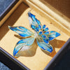 Brigette Orchid Sculpted Resin Brooch - An elegant floral brooch available in blue, pink, or purple, with shimmering crystals and semi-translucent resin.