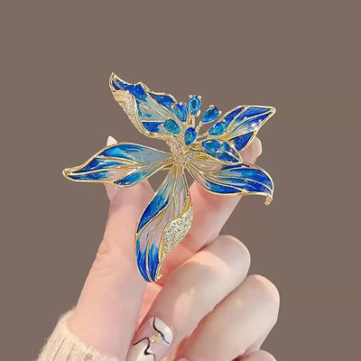 Brigette Orchid Sculpted Resin Brooch - An elegant floral brooch available in blue, pink, or purple, with shimmering crystals and semi-translucent resin.