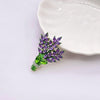 Brighid Lavender Sprig Brooch - A medium-sized crystal brooch shaped like a trio of delicate sprigs of lavender tied together, featuring lovely purple, green, and white crystals.
