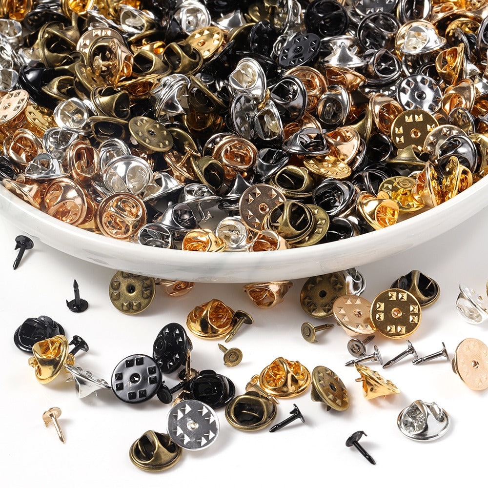 Brooch Pin & Cap Sets - An assortment of small brooch pin backs used in the creation of jewellery.