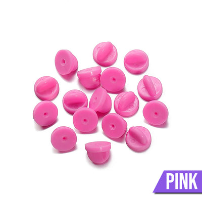 Loose Brooch Pin Backs - A pile of rubber brooch backs in pink.
