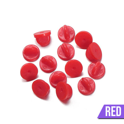 Loose Brooch Pin Backs - A pile of rubber brooch backs in red.