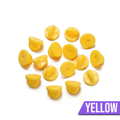Loose Brooch Pin Backs - A pile of rubber brooch backs in yellow.